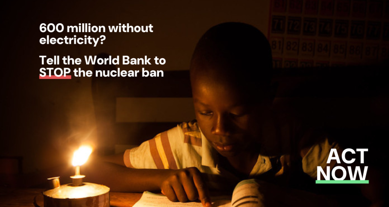 A boy sits reading with only the light of a paraffin lamp.